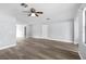 Spacious living room featuring modern flooring, light walls, and a ceiling fan at 116 Hermes Rd, Venice, FL 34293