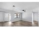 Bright living room with modern flooring, light walls, and a window to the front yard at 116 Hermes Rd, Venice, FL 34293