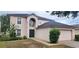 Charming two-story home with well-maintained lawn and manicured garden beds at 1209 Alhambra Crest Dr, Ruskin, FL 33570