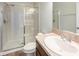 Bright bathroom featuring a glass shower, a granite countertop, and a white porcelain sink at 12117 Streambed Dr, Riverview, FL 33579
