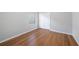 Bright bedroom featuring hardwood floors, neutral walls, and a closet with bi-fold doors at 12117 Streambed Dr, Riverview, FL 33579