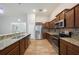 Modern kitchen with granite countertops, stainless steel appliances, and wood flooring at 12117 Streambed Dr, Riverview, FL 33579