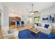 Spacious living room with a ceiling fan, blue rug, and adjoined kitchen and dining area at 12117 Streambed Dr, Riverview, FL 33579