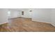 Spacious living room with wood tile floors and natural light from the windows at 12117 Streambed Dr, Riverview, FL 33579