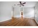 Large main bedroom with neutral paint, wood floors, a ceiling fan, and natural light at 12117 Streambed Dr, Riverview, FL 33579