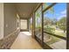 Screened lanai featuring stone accents, tiled floor and an outdoor view at 12117 Streambed Dr, Riverview, FL 33579