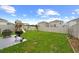 Large backyard with well-maintained grass, playset, grill and mature trees at 17071 Oval Rum Dr, Wimauma, FL 33598