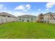 The backyard features grass, a playset, an outdoor grill, and privacy fence at 17071 Oval Rum Dr, Wimauma, FL 33598