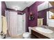 The bathroom features a shower, toilet, sink, mirror, and a decorative light fixture at 17071 Oval Rum Dr, Wimauma, FL 33598