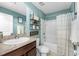 Cozy bathroom featuring a vanity, toilet, shower-tub combination with decorative shelves at 17071 Oval Rum Dr, Wimauma, FL 33598