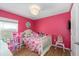 Bright bedroom featuring colorful walls, a bed, and furnishings at 17071 Oval Rum Dr, Wimauma, FL 33598