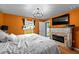 This bedroom features a fireplace, television, window, and stylish lighting at 17071 Oval Rum Dr, Wimauma, FL 33598