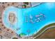 Aerial view of huge community pool with unique floating obstacle course at 17071 Oval Rum Dr, Wimauma, FL 33598
