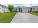 Charming single-Gathering home featuring a well-maintained lawn, driveway, and one-car garage at 17071 Oval Rum Dr, Wimauma, FL 33598