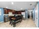 Eat-in kitchen with wooden cabinets, stainless steel appliances, and dining table at 17071 Oval Rum Dr, Wimauma, FL 33598