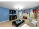 Comfortable living room featuring stylish décor, fireplace, and abundant natural light at 17071 Oval Rum Dr, Wimauma, FL 33598