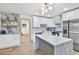 Bright kitchen featuring marble countertops, custom cabinetry, and stylish modern lighting at 203 Driftwood W Dr, Palm Harbor, FL 34683