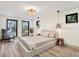 Serene main bedroom features neutral tones, wood floors, natural light, and cozy accent lighting at 203 Driftwood W Dr, Palm Harbor, FL 34683