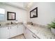 Large bathroom featuring a granite countertop, double sinks, and a modern design at 2567 Frisco Dr, Clearwater, FL 33761