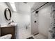 Modern bathroom with a walk-in shower, sleek fixtures, and stylish tile work at 2567 Frisco Dr, Clearwater, FL 33761