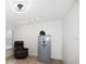 Stylish bedroom with wood-look floors, comfortable chair, and secure safe for peace of mind at 2567 Frisco Dr, Clearwater, FL 33761
