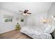 Bright bedroom with wood-look floors, multiple windows, a closet, and a comfortable bed at 2567 Frisco Dr, Clearwater, FL 33761