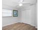Bright bedroom featuring wood-look floors, a spacious closet, and modern decor for comfortable living at 2567 Frisco Dr, Clearwater, FL 33761