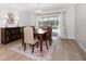 Elegant dining room with a wood table, decorative rug, and sliding glass doors to the outdoor patio at 2567 Frisco Dr, Clearwater, FL 33761