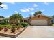 Beautiful single-story home with a well-manicured front yard and a driveway leading to a two-car garage at 2567 Frisco Dr, Clearwater, FL 33761