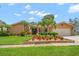 Charming single-story home with a beautifully landscaped front yard, and stone accents at 2567 Frisco Dr, Clearwater, FL 33761
