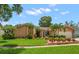 Charming single-story home with stone accents, lush landscaping, and a well-manicured lawn at 2567 Frisco Dr, Clearwater, FL 33761