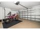 Spacious two-car garage with epoxy floor, showcasing a motorcycle, and ample storage space at 2567 Frisco Dr, Clearwater, FL 33761