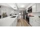 Bright kitchen with stainless steel appliances, white cabinets, and modern countertops at 2567 Frisco Dr, Clearwater, FL 33761