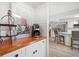 Bright kitchen featuring wood countertops, white cabinets, stainless steel appliances, and breakfast bar seating at 2567 Frisco Dr, Clearwater, FL 33761