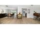 Spacious open-concept living and dining area with wood floors and views of the pool at 2567 Frisco Dr, Clearwater, FL 33761