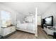 Spacious main bedroom with a four-poster bed, ceiling fan, and ample closet space at 2567 Frisco Dr, Clearwater, FL 33761