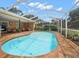 Inviting pool with a screened-in enclosure and brick-paver deck, perfect for outdoor entertaining at 2567 Frisco Dr, Clearwater, FL 33761