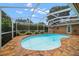 Inviting screened-in pool with brick paver patio, perfect for outdoor relaxation and entertaining at 2567 Frisco Dr, Clearwater, FL 33761