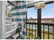 Inviting balcony featuring a sewing machine setup and relaxing view of the community pool, blending hobbies and leisure at 2591 Countryside Blvd # 5304, Clearwater, FL 33761