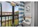Charming balcony with blue and white decor, offering a view of the community pool and green landscape at 2591 Countryside Blvd # 5304, Clearwater, FL 33761