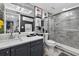 Modern bathroom features gray tiling, sliding glass shower doors, stylish vanity, and contemporary decorative accents at 2591 Countryside Blvd # 5304, Clearwater, FL 33761