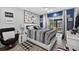 Cozy bedroom with black and white striped bedding, and a sliding glass door to the patio at 2591 Countryside Blvd # 5304, Clearwater, FL 33761