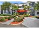 Inviting building exterior showcases lush landscaping and well-maintained grounds, with mature palms and flowering shrubs at 2591 Countryside Blvd # 5304, Clearwater, FL 33761