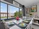 The dining area showcases modern decor and large windows with views of the community pool at 2591 Countryside Blvd # 5304, Clearwater, FL 33761