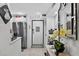Bright hallway featuring modern finishes, leading to stainless steel refrigerator, ample storage, and stylish decor at 2591 Countryside Blvd # 5304, Clearwater, FL 33761