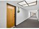 Well-lit hallway leading to unit 304, featuring a clean and inviting atmosphere at 2591 Countryside Blvd # 5304, Clearwater, FL 33761