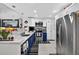 Modern kitchen with stainless steel appliances, granite countertops, blue cabinets and open design at 2591 Countryside Blvd # 5304, Clearwater, FL 33761
