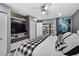 Well-lit main bedroom with a ceiling fan, modern decor, and access to a balcony offering a relaxing atmosphere at 2591 Countryside Blvd # 5304, Clearwater, FL 33761
