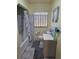 Clean bathroom featuring a shower/tub combo with neutral colored tile and flooring at 2612 E 17Th Ave, Tampa, FL 33605