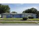 Charming single-story home with a blue facade, well-maintained lawn, and attached garage at 2612 E 17Th Ave, Tampa, FL 33605